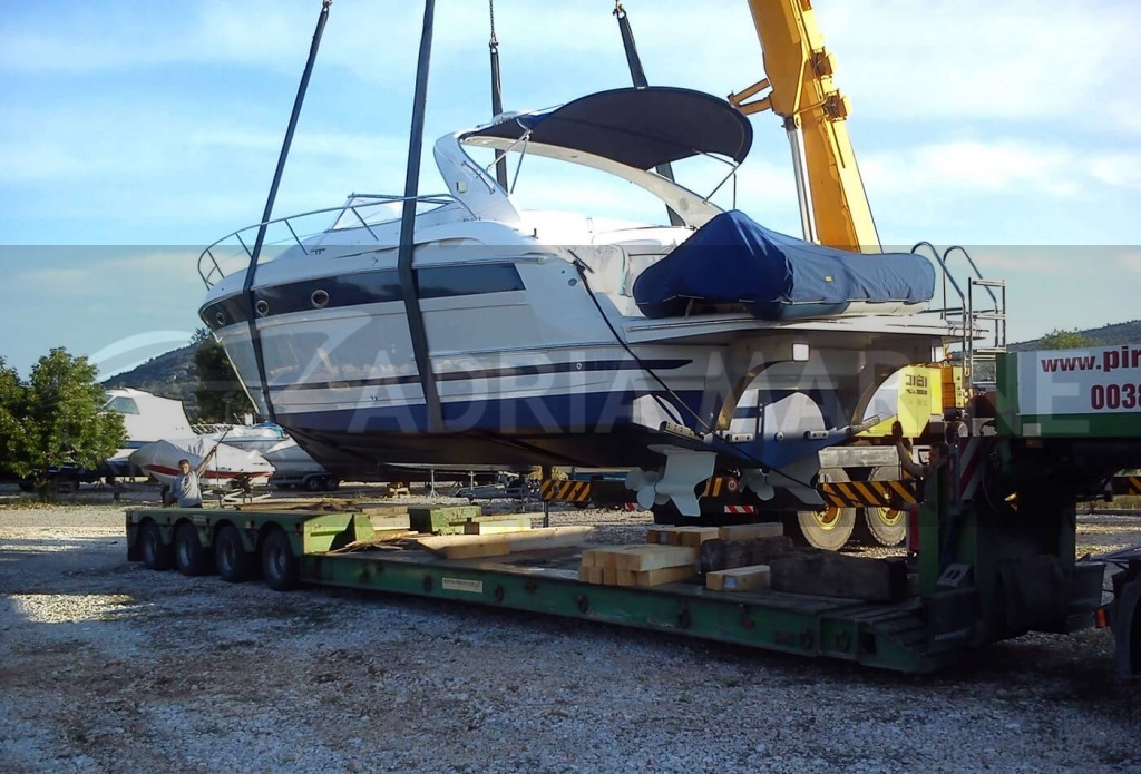 Unload yacht from truck to dry dock